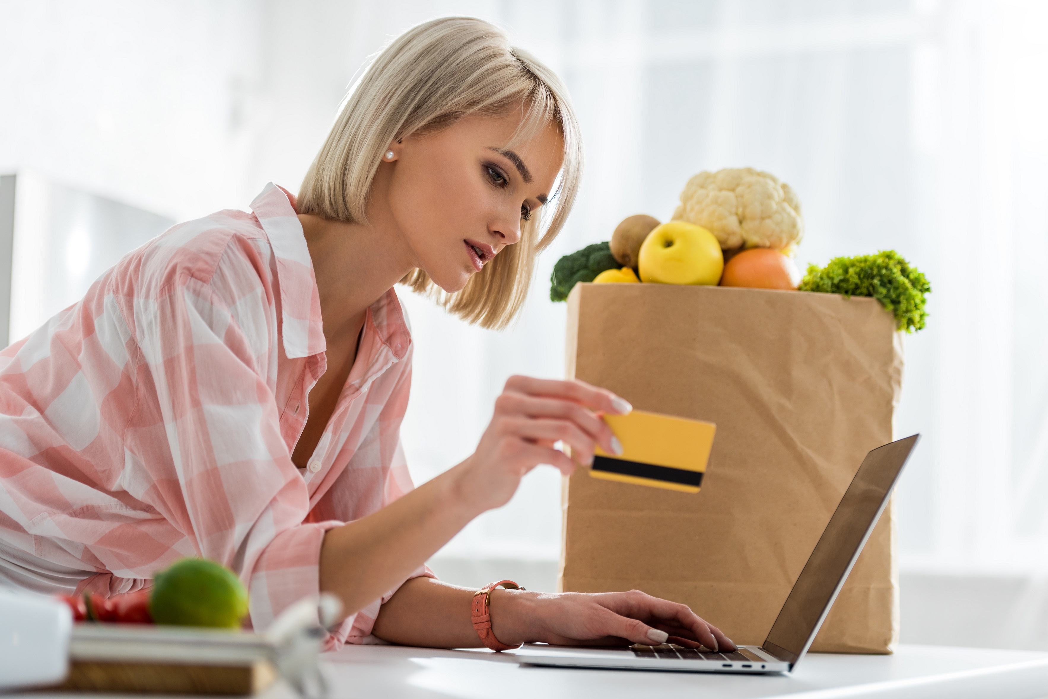 Attractive Blonde Girl Holding Credit Card While U LJ4D6JA